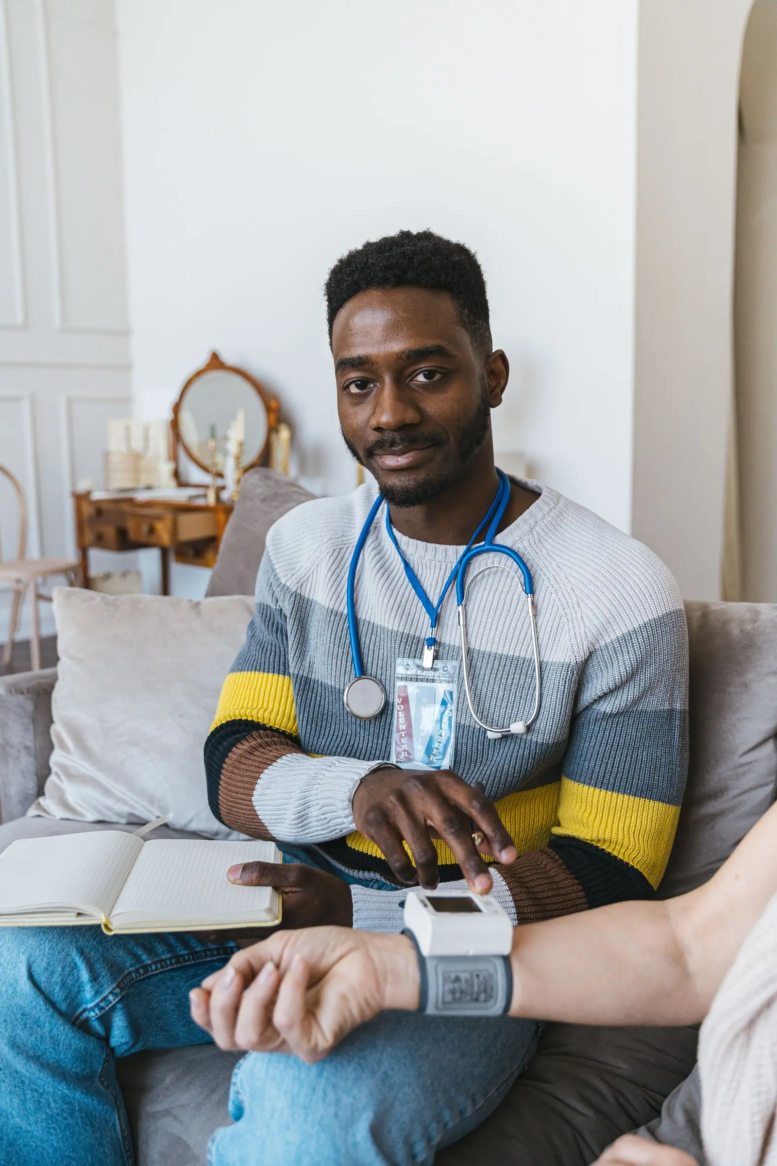 Health worker with a stethoscope on a home visit